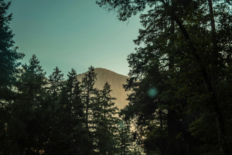 the large rock has a mountain in the background