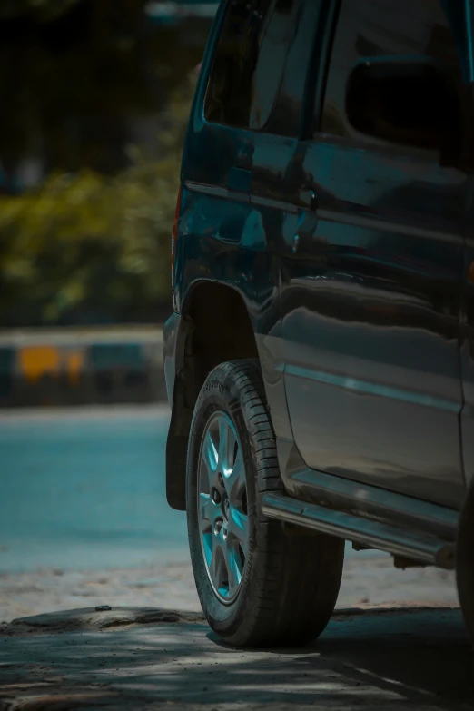 a close up of the tire on a blue car