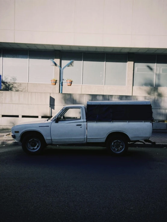 an old pickup truck parked on the side of the street