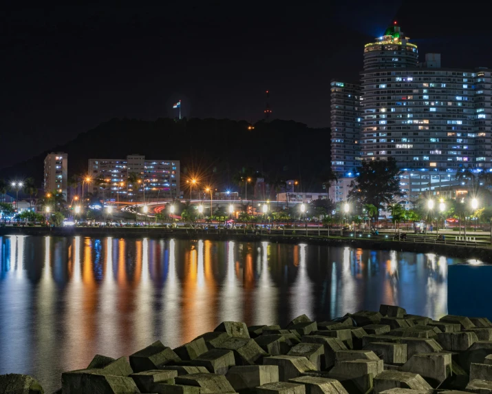 a city is reflected in the water of a bay