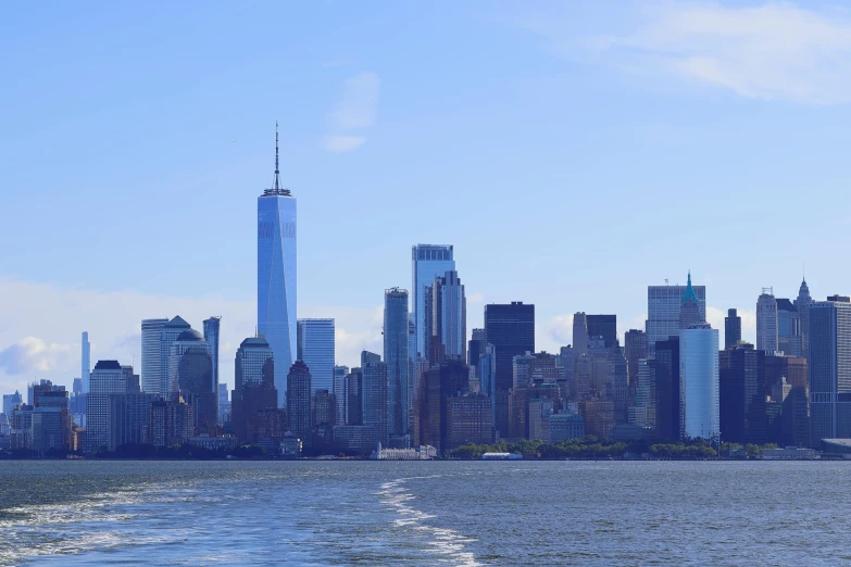 a boat sails toward the skyline as it passes through the bay