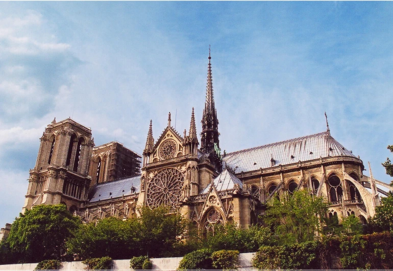 an old gothic church sitting on a hill