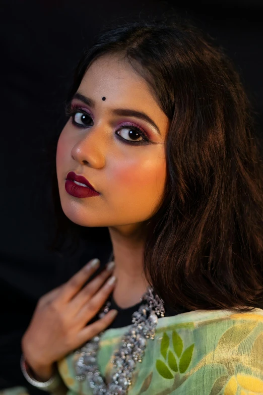 an attractive woman wearing jewelled jewelry and a colorful sari