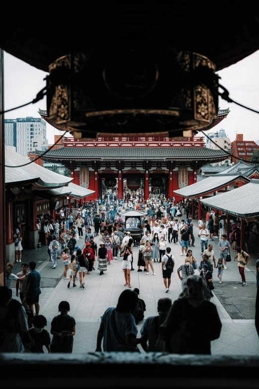 a group of people walking around a city