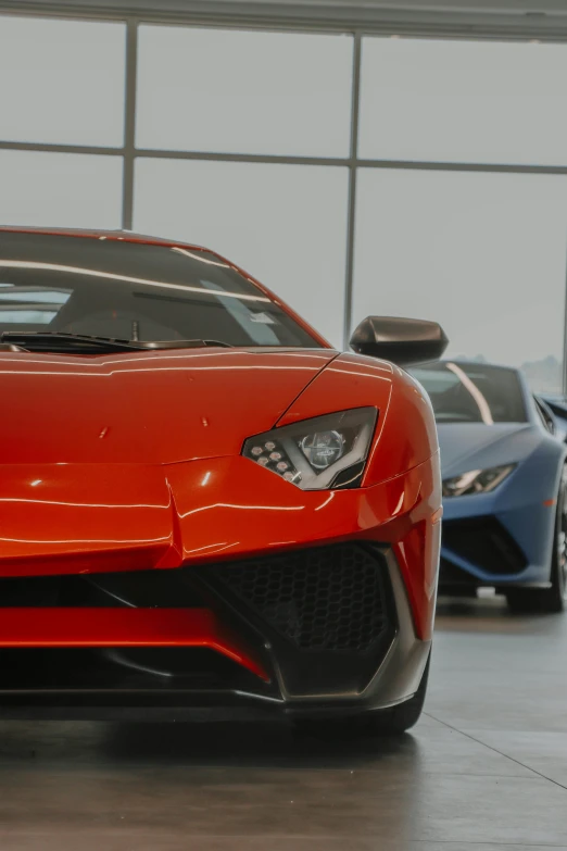 four different color lamb cars in a garage