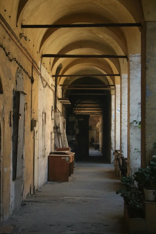 an open hallway with old doors and archways