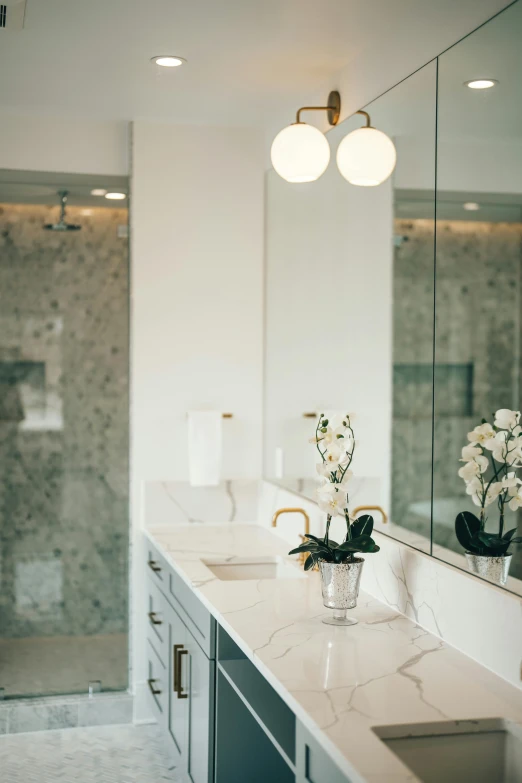 a bathroom with some vases and mirrors on the wall