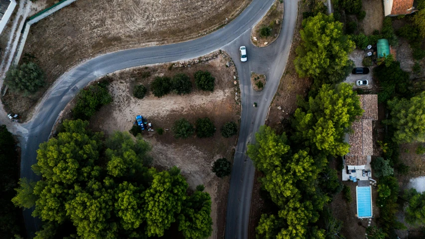 top view of residential area with parking lot and paved road