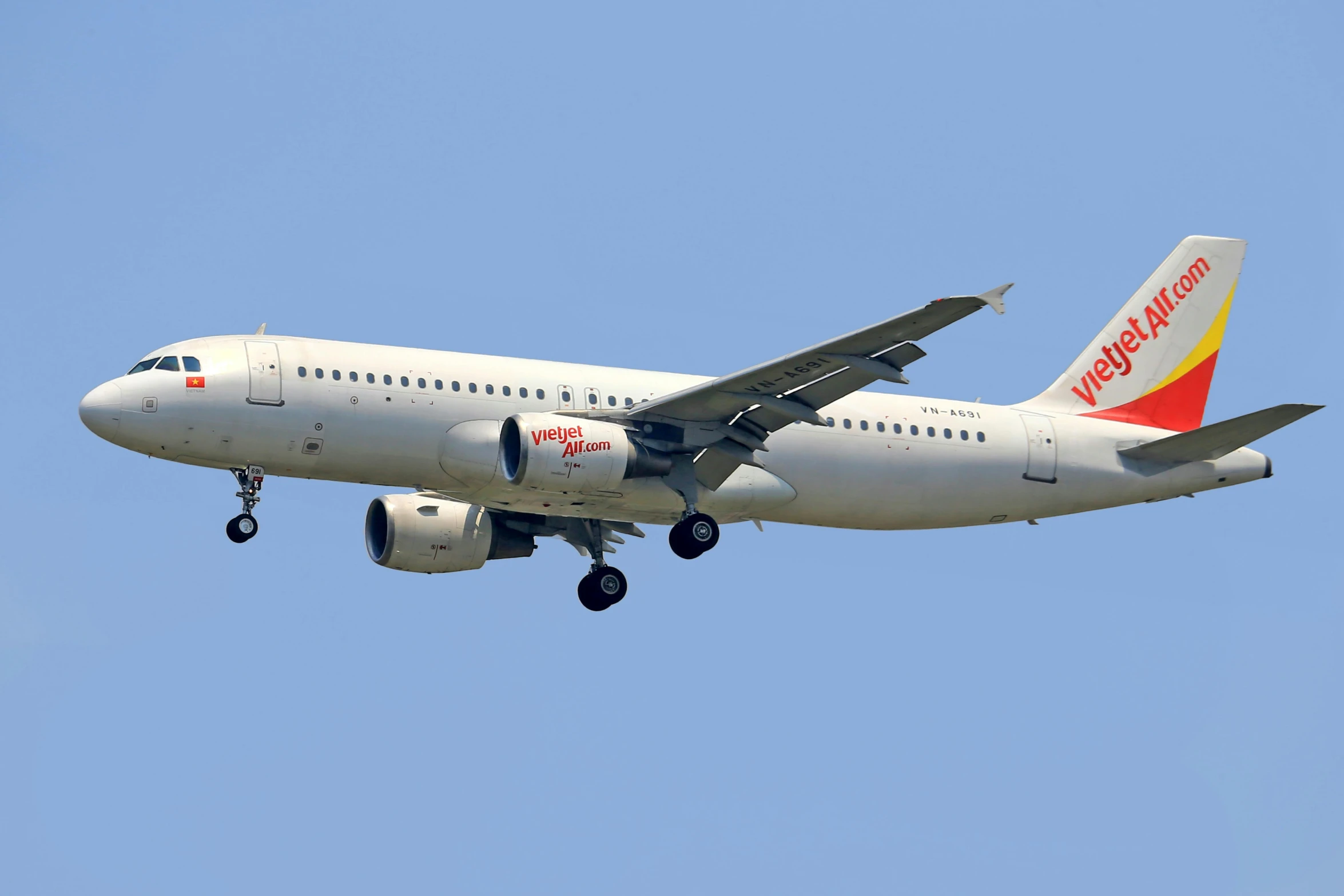 the large commercial passenger airplane is flying through the sky