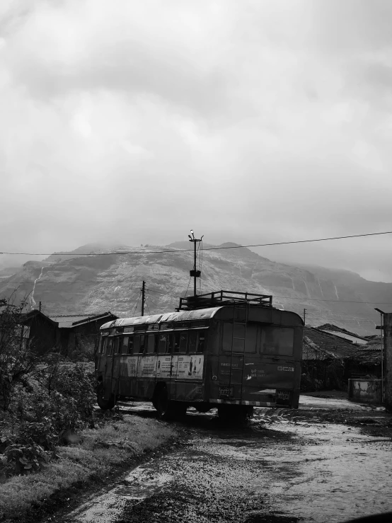 an old train sitting on the tracks in the fog