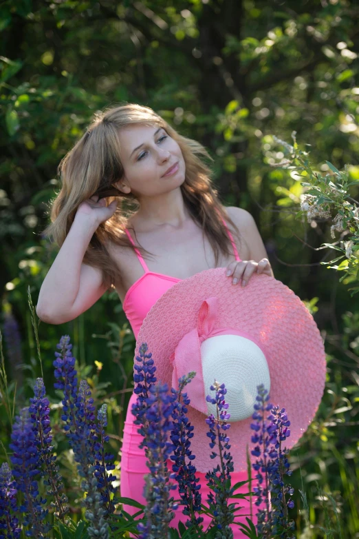 the woman is posing in her pink bathing suit