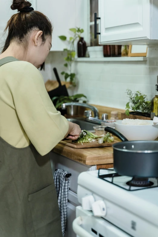 a woman  up vegetables in a kitchen