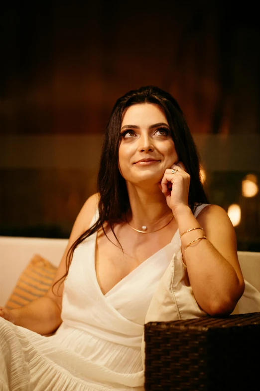 a woman sitting in a chair and smiling