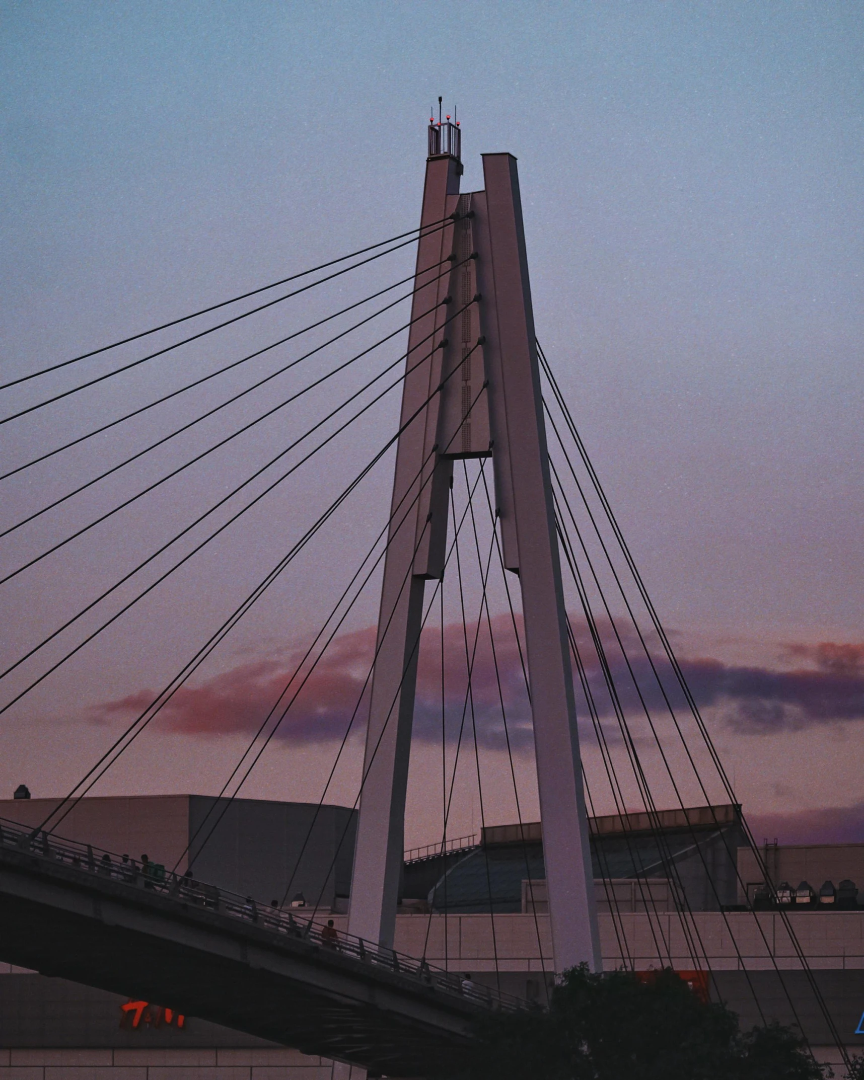 a very long bridge with a tall tower