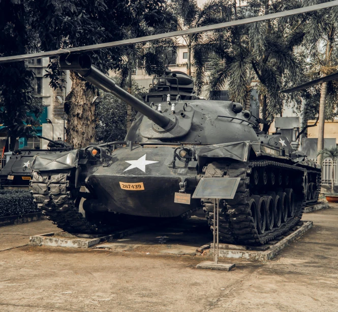 a military tank in the middle of a parking lot