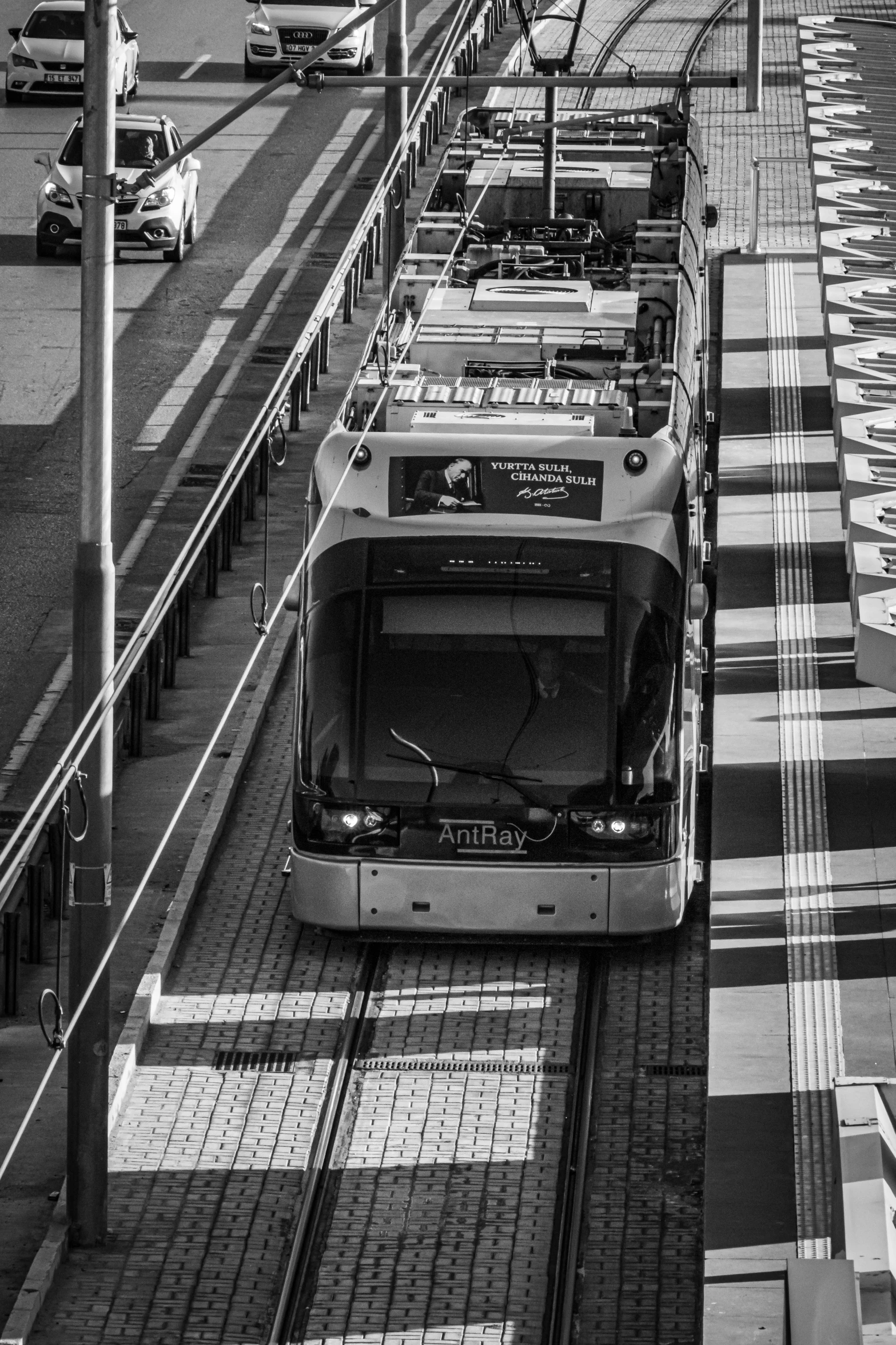 the train is moving along the tracks in the black and white po