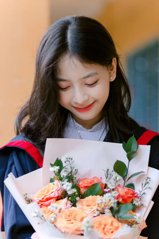 a young woman holding a bouquet of flowers in her hands