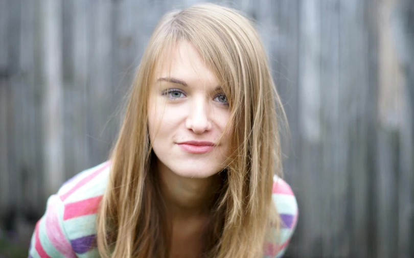 a  looking into the camera with long hair