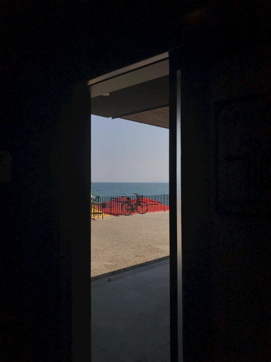 an open door that opens to a sandy beach