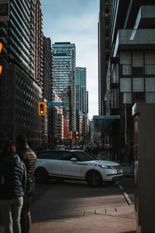 a car passing through an intersection near a yellow traffic light