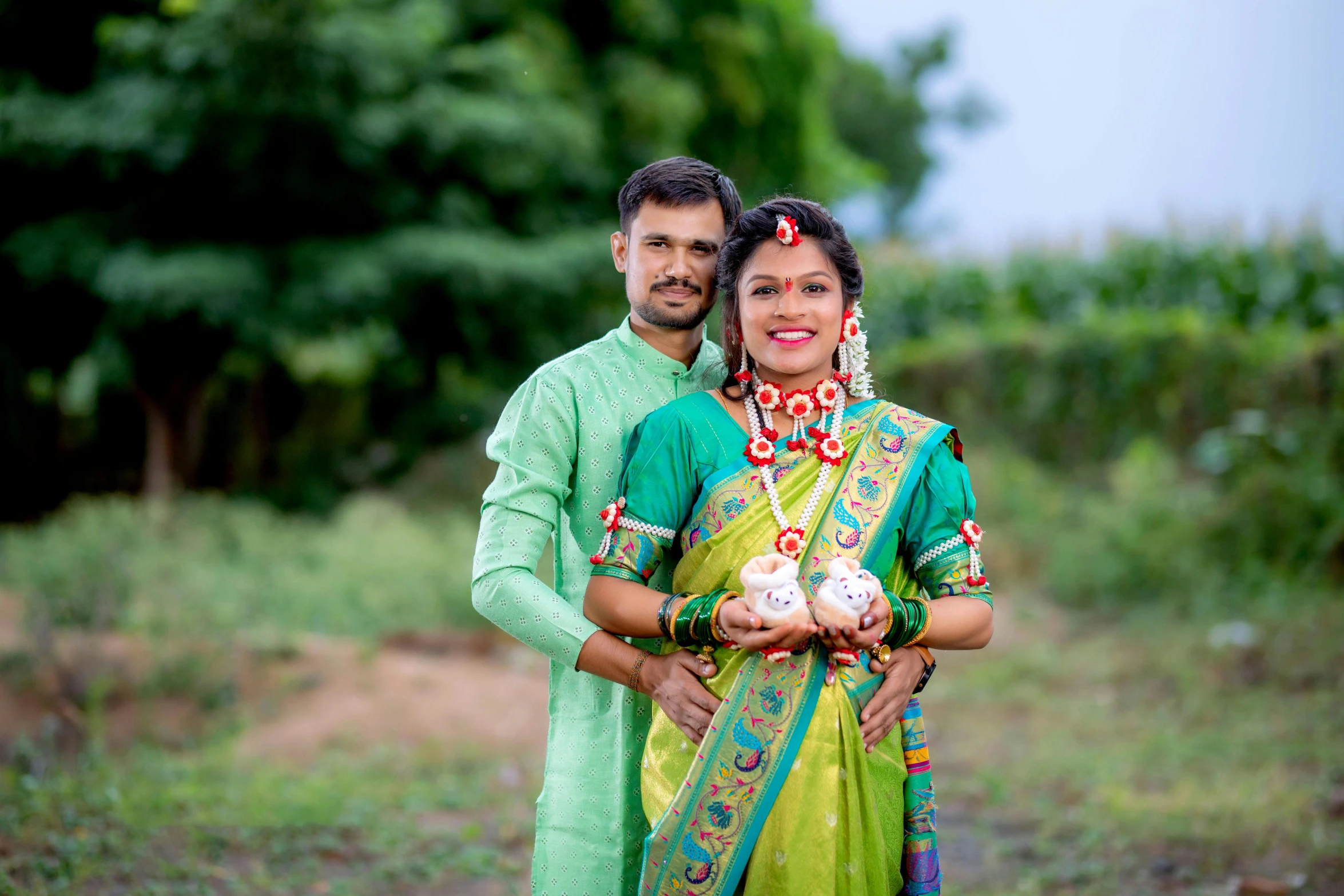 a man and woman in traditional attire posing for the camera