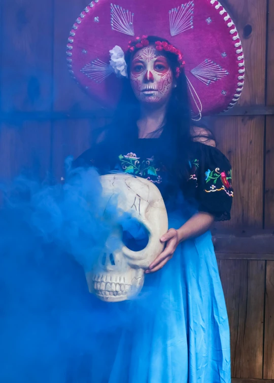 a woman wearing a colorful dress and skull mask