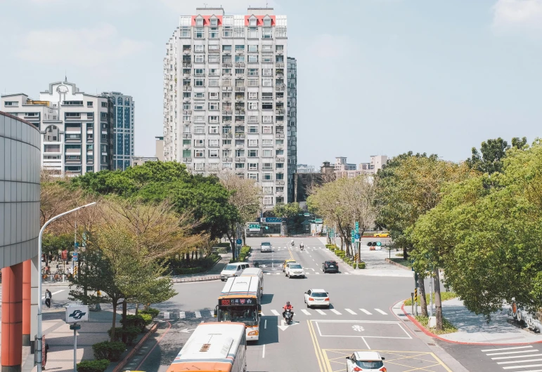 there are cars and a bus on the street in this city