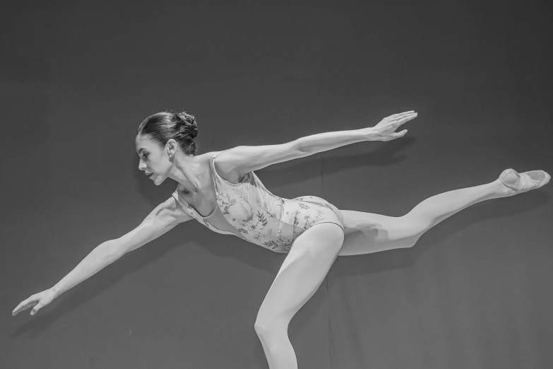 an adult female in a body suit performing a move