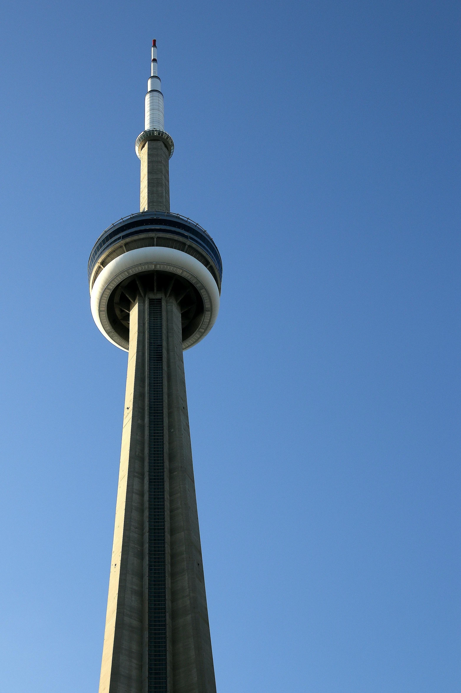 the view of the top of a tall building with a clock at the top