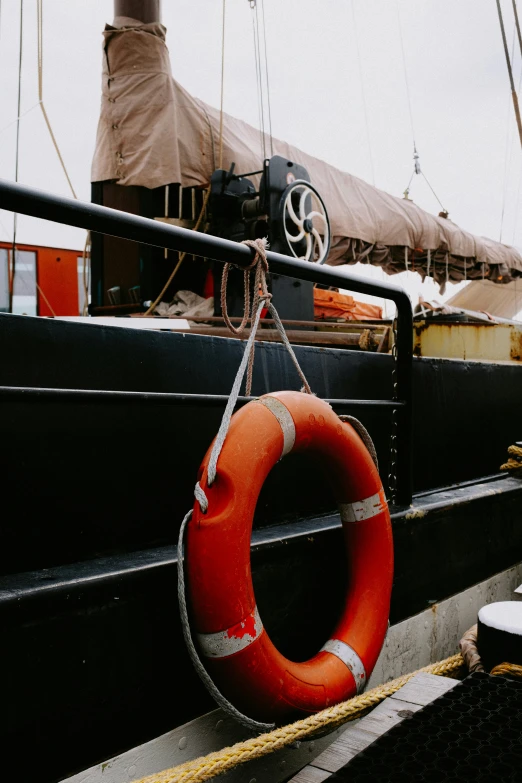 an orange life preserver is hanging on the side of a boat