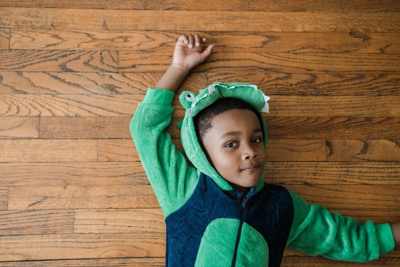 a little boy that is laying on the ground