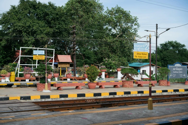 a train track surrounded by plant filled platforms