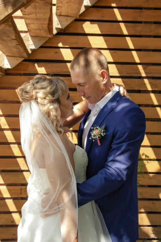 there is a man in a blue suit and woman in white