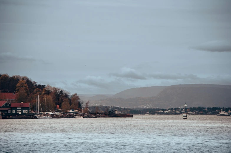 boats on the water with houses in the background