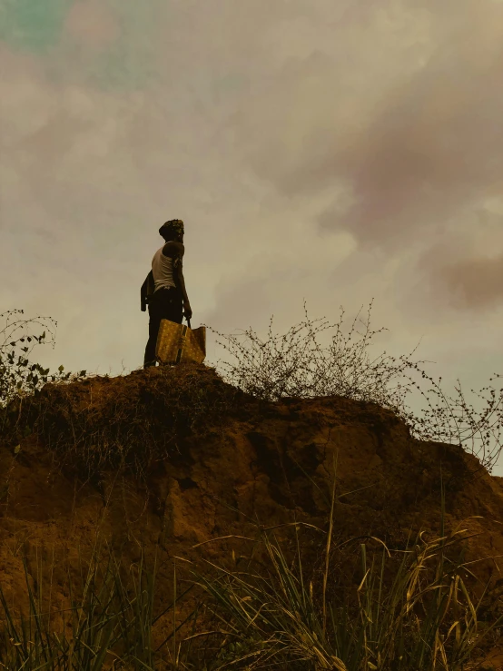 a man sits on top of a hill