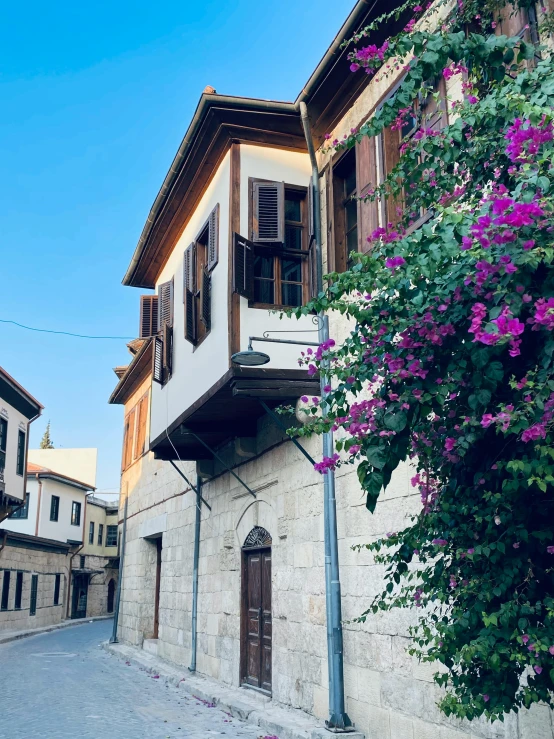 an old stone building with two balconies and windows