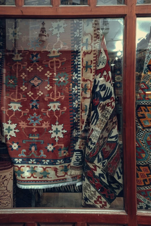 many pieces of cloth displayed in a glass window