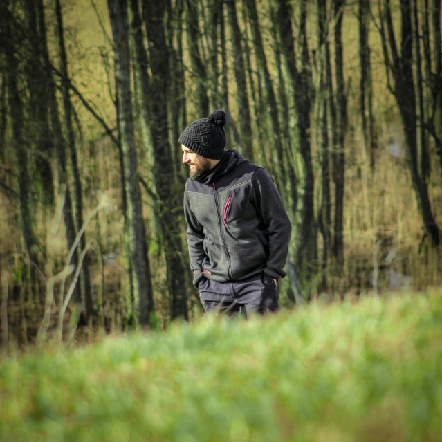 a man walking in the woods in winter clothing