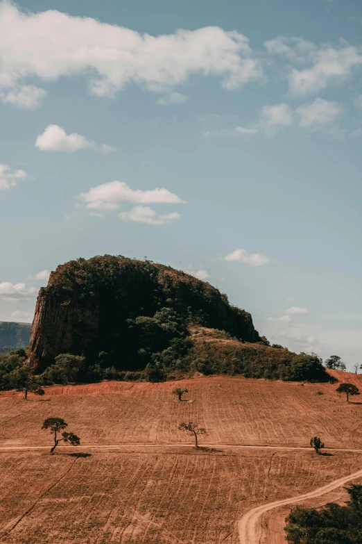 an aerial view of a barren landscape with a large mound of dirt on it