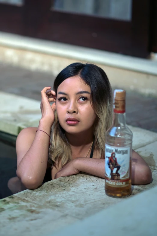 a  leaning on the side of a building in front of a bottle