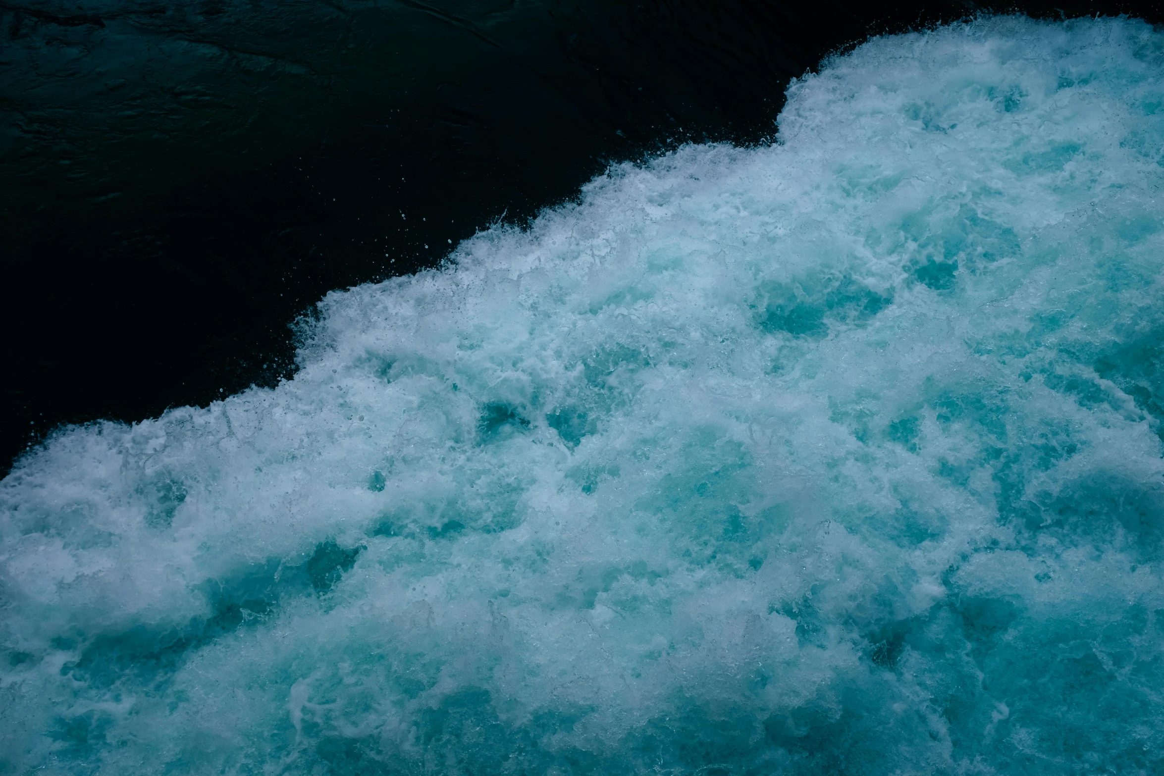 waves crashing against the shore and breaking