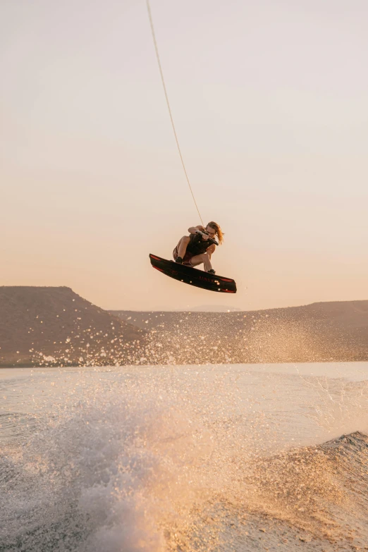 a man riding skis while jumping over the water