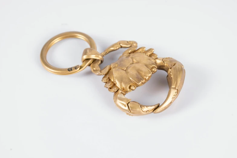 an antique gold charm is shown on a white background