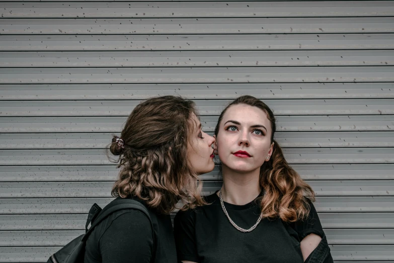 two s stand next to each other in front of a garage door