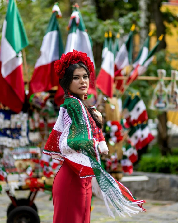 an oriental woman in traditional clothing and scarf at the end of an outdoor parade