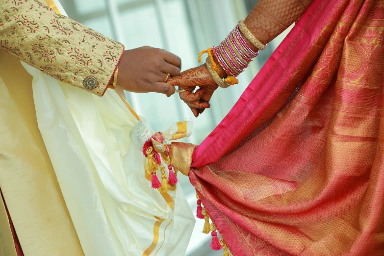 a person tying a tie of sari