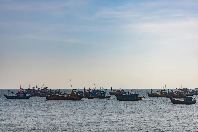 a lot of small fishing boats in the water