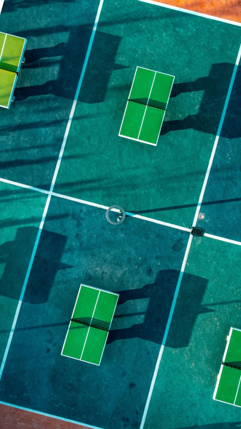 several tennis courts with green and red surfaces