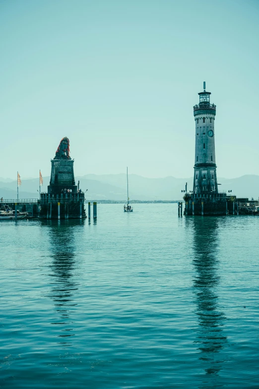 the light house on the dock is on the ocean