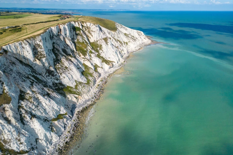 an aerial view of the white cliffs overlooking the ocean